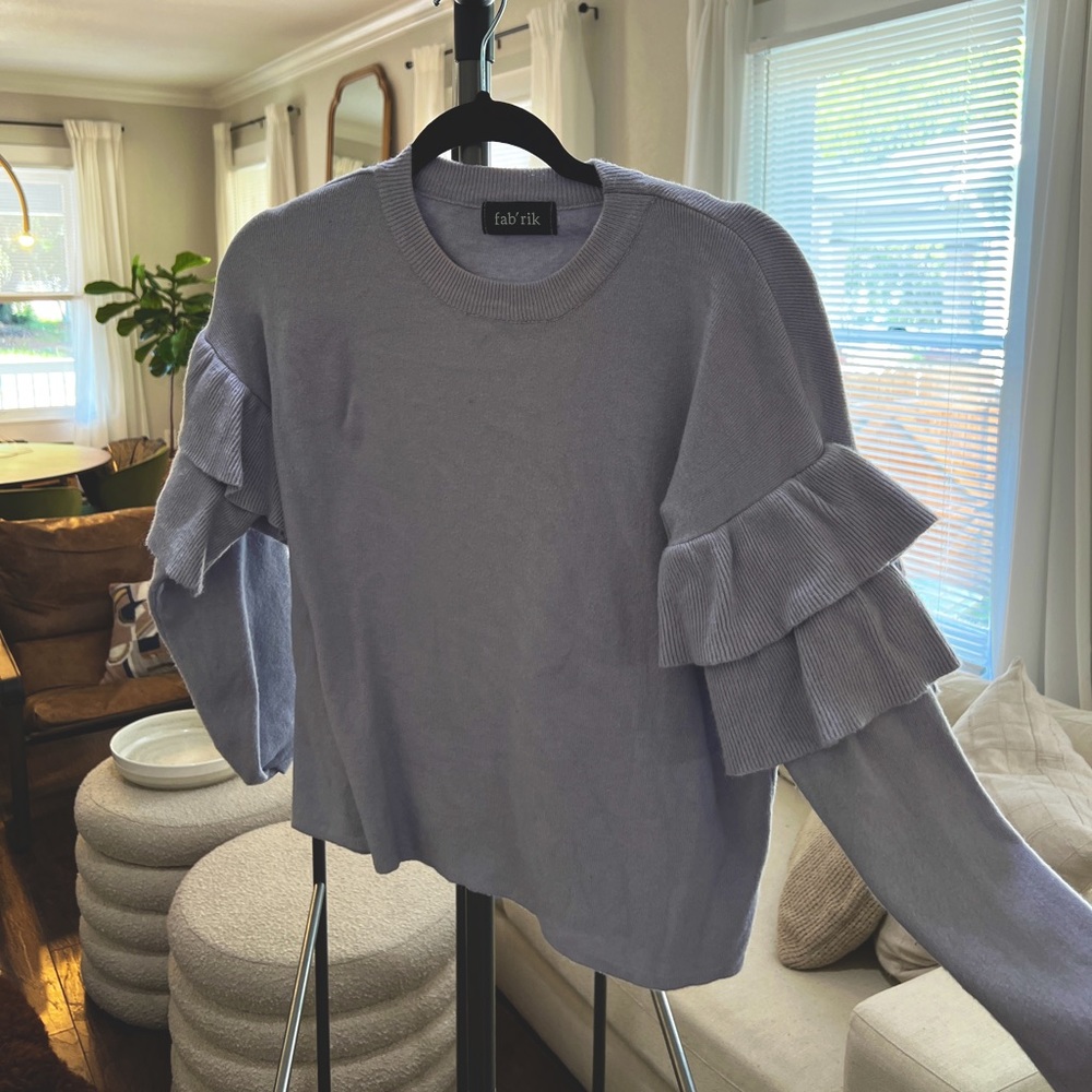 Ruffle arm sweater. Super cute and comfortable. Thicker material.